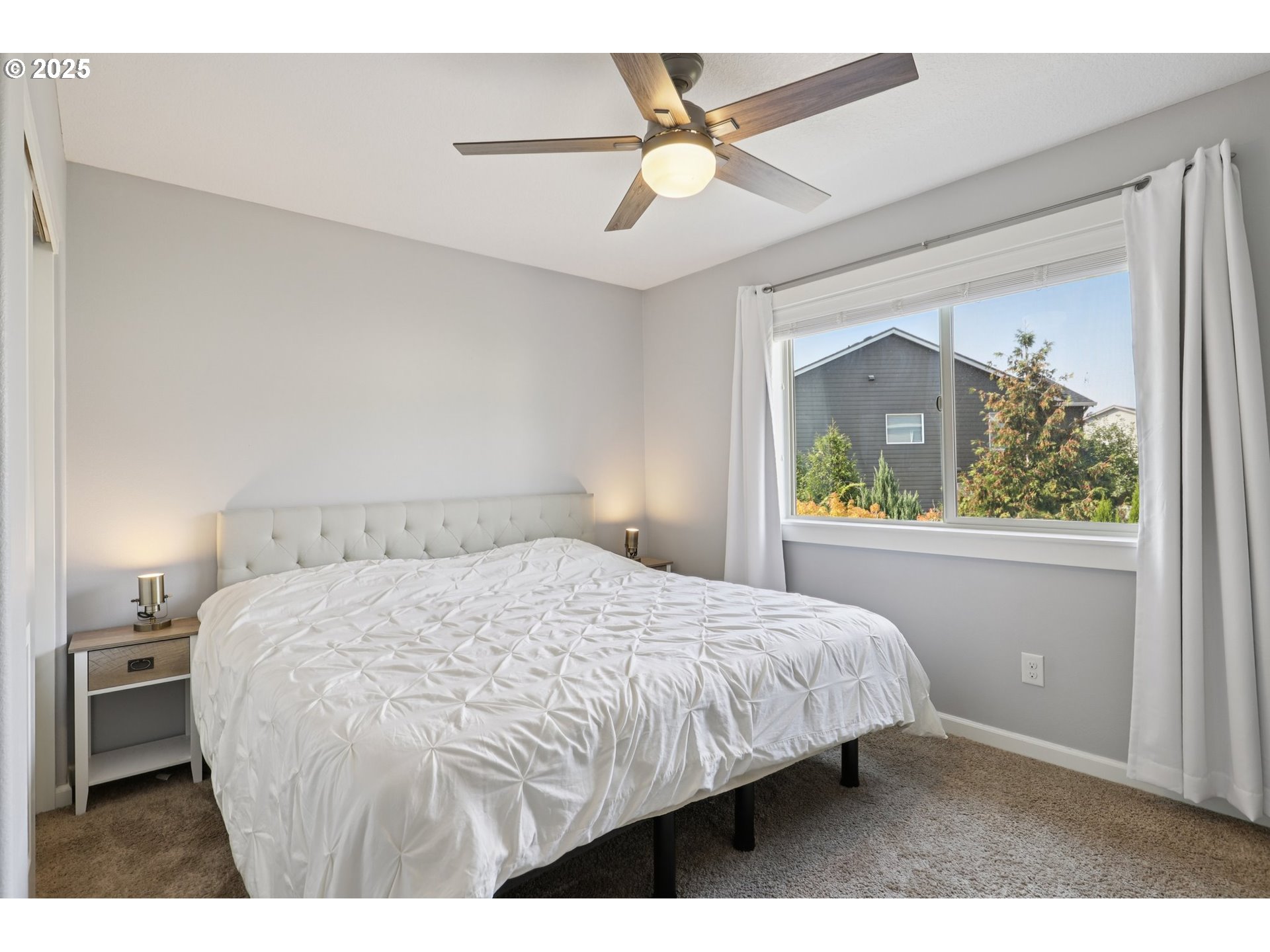 3520 North 6th Circle Ridgefield, WA 98642 - Photo 23 of 27 a bedroom with a bed a window and a chandelier