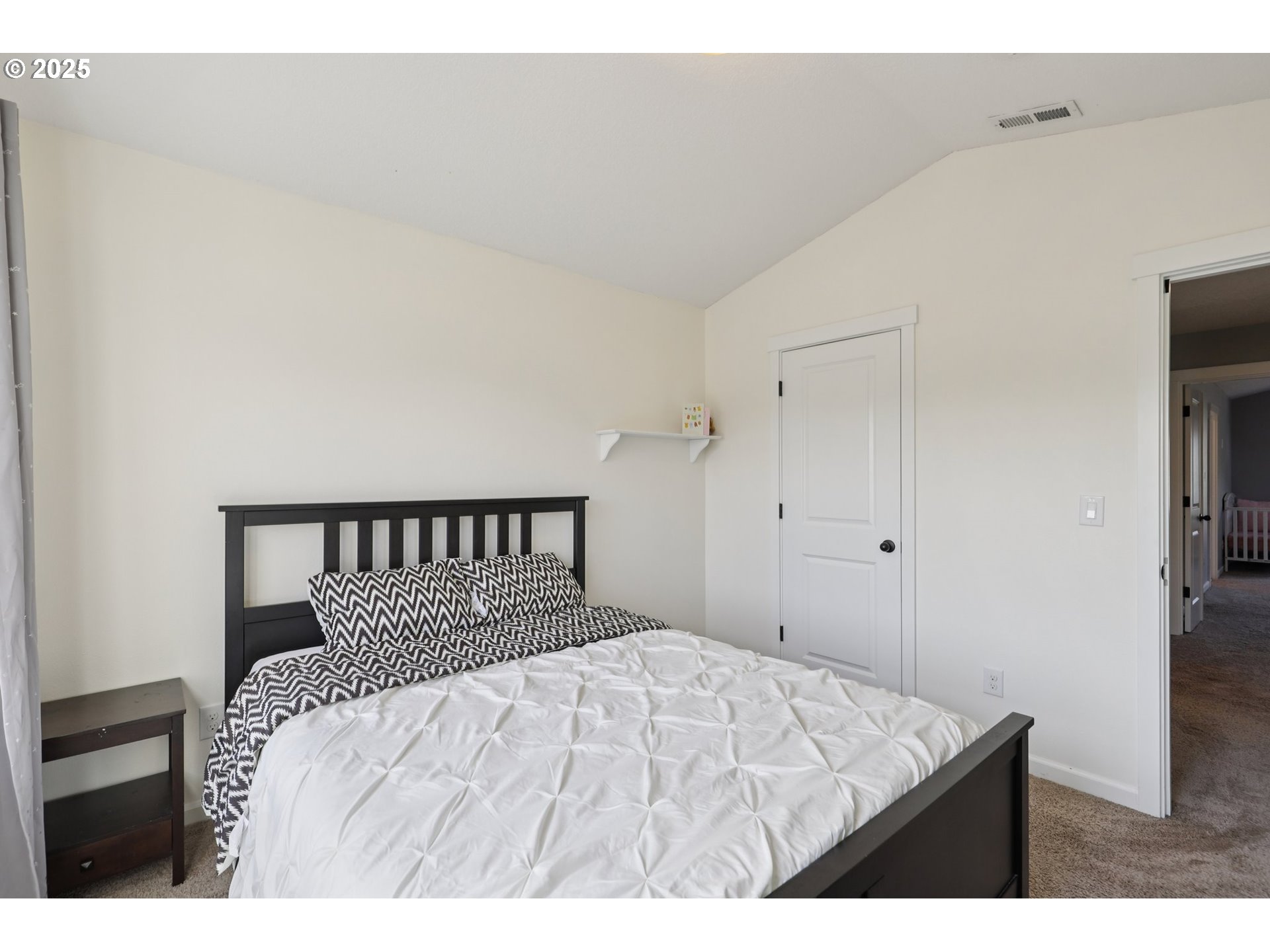 3520 North 6th Circle Ridgefield, WA 98642 - Photo 27 of 27 a large bed in a bedroom with a tv