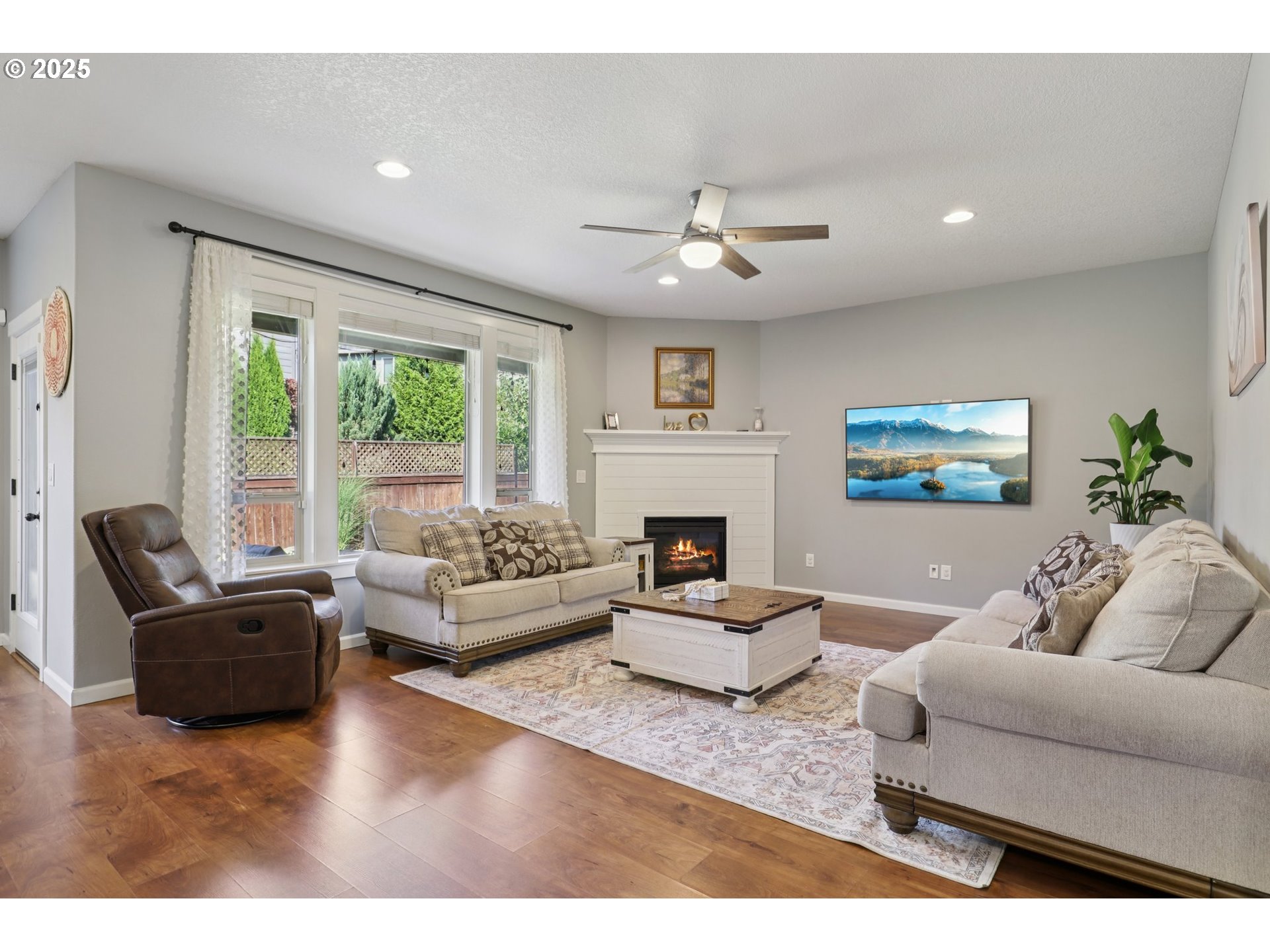 3520 North 6th Circle Ridgefield, WA 98642 - Photo 6 of 27 a living room with furniture a fireplace and a large window