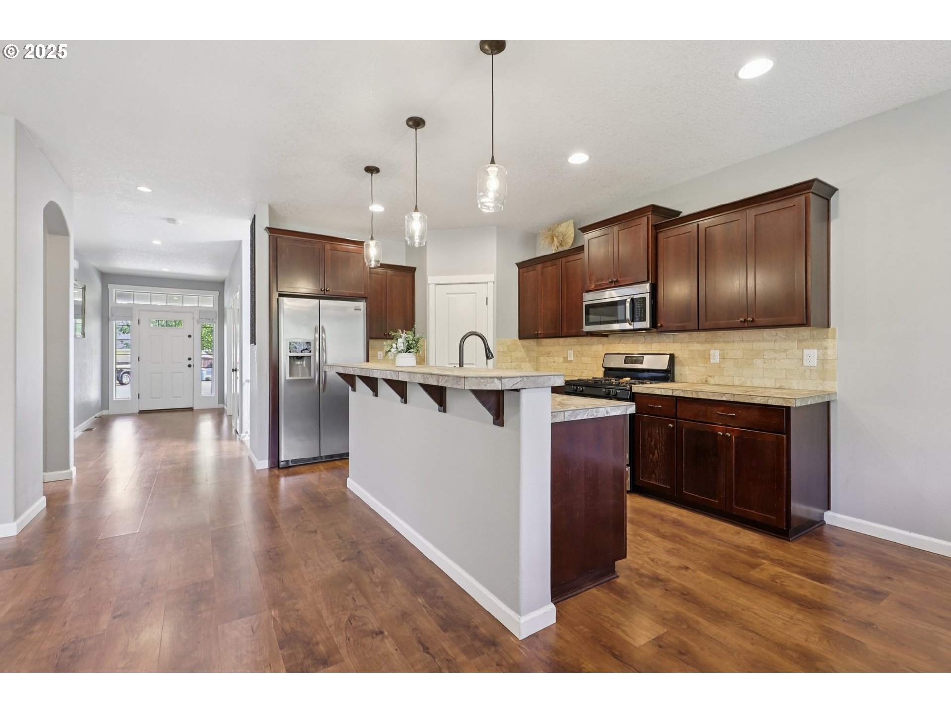3520 North 6th Circle Ridgefield, WA 98642 - Photo 10 of 27 a kitchen with kitchen island granite countertop wooden cabinets and stainless steel appliances
