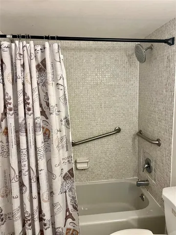 a bathroom with a shower and a bathtub