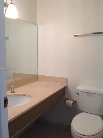 a bathroom with a sink a toilet and vanity