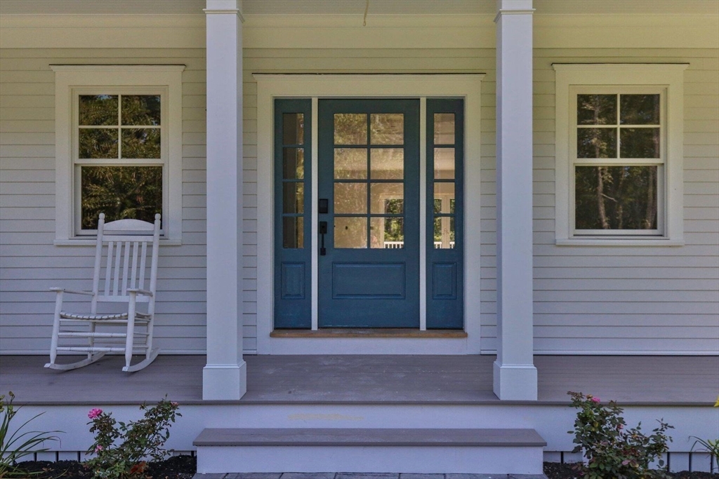 1025 Orleans Road Harwich, MA 02645 - Photo 2 of 39 a front view of a house with a window and potted plants