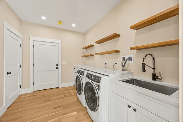 a utility room with sink dryer and washer