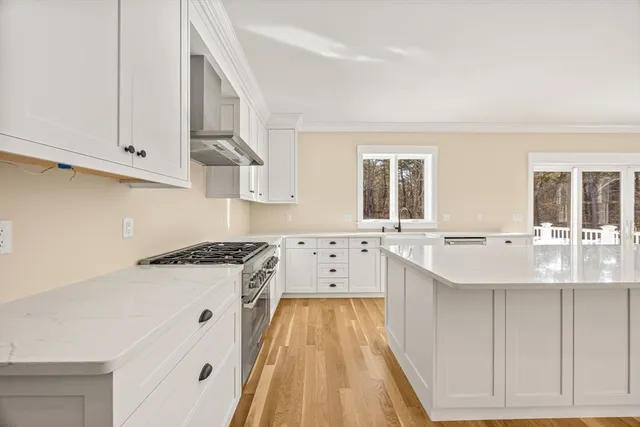 a kitchen with stainless steel appliances granite countertop a sink stove and cabinets