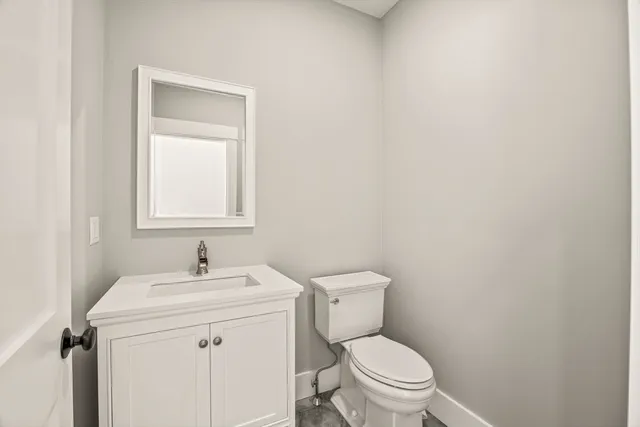 a bathroom with a sink toilet and a mirror