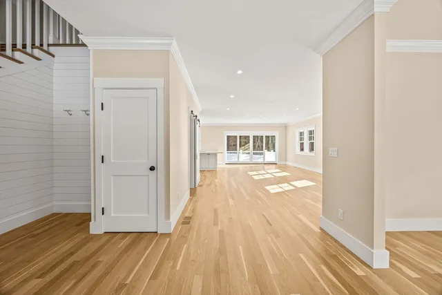 a view of a room with wooden floor and a window