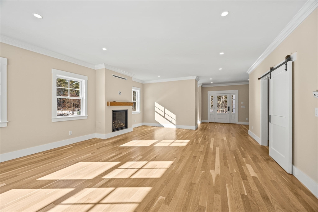 1025 Orleans Road Harwich, MA 02645 - Photo 29 of 39 a view of a livingroom with wooden floor and a kitchen