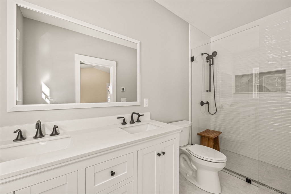 1025 Orleans Road Harwich, MA 02645 - Photo 30 of 39 a bathroom with a sink a toilet and a mirror