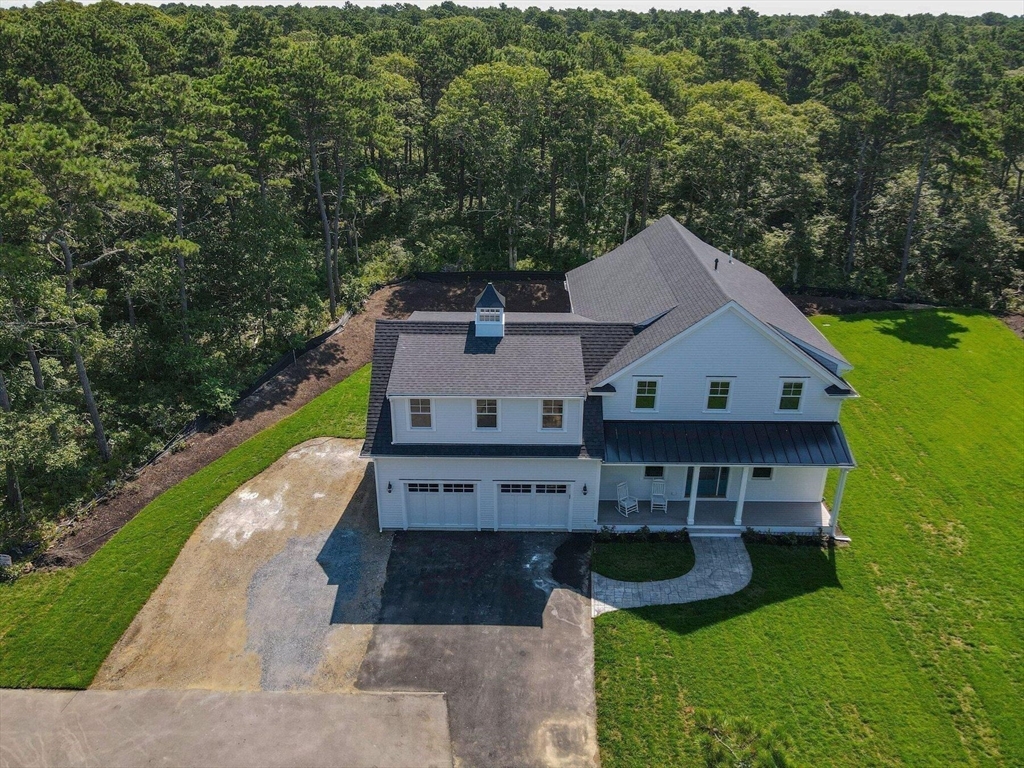 1025 Orleans Road Harwich, MA 02645 - Photo 3 of 39 a view of house with garden and tall trees