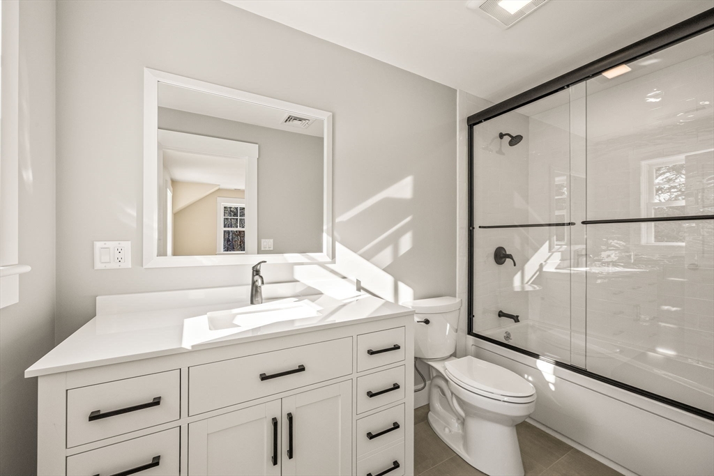 1025 Orleans Road Harwich, MA 02645 - Photo 34 of 39 a bathroom with a sink a toilet and a mirror