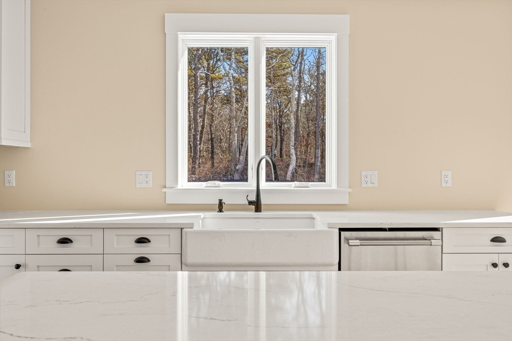 1025 Orleans Road Harwich, MA 02645 - Photo 36 of 39 a white kitchen with sink and window
