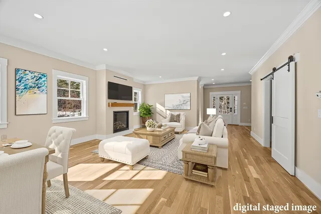a living room with fireplace furniture and a wooden floor