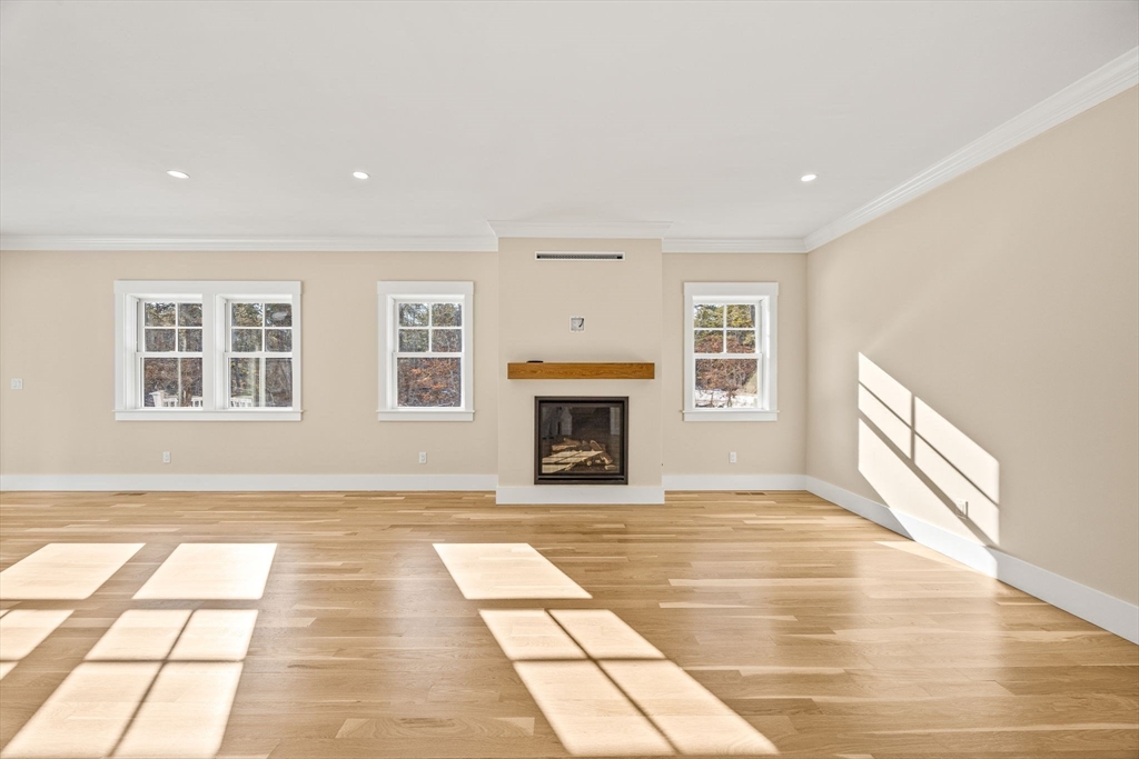 1025 Orleans Road Harwich, MA 02645 - Photo 10 of 39 a view of an empty room with a fireplace and a window