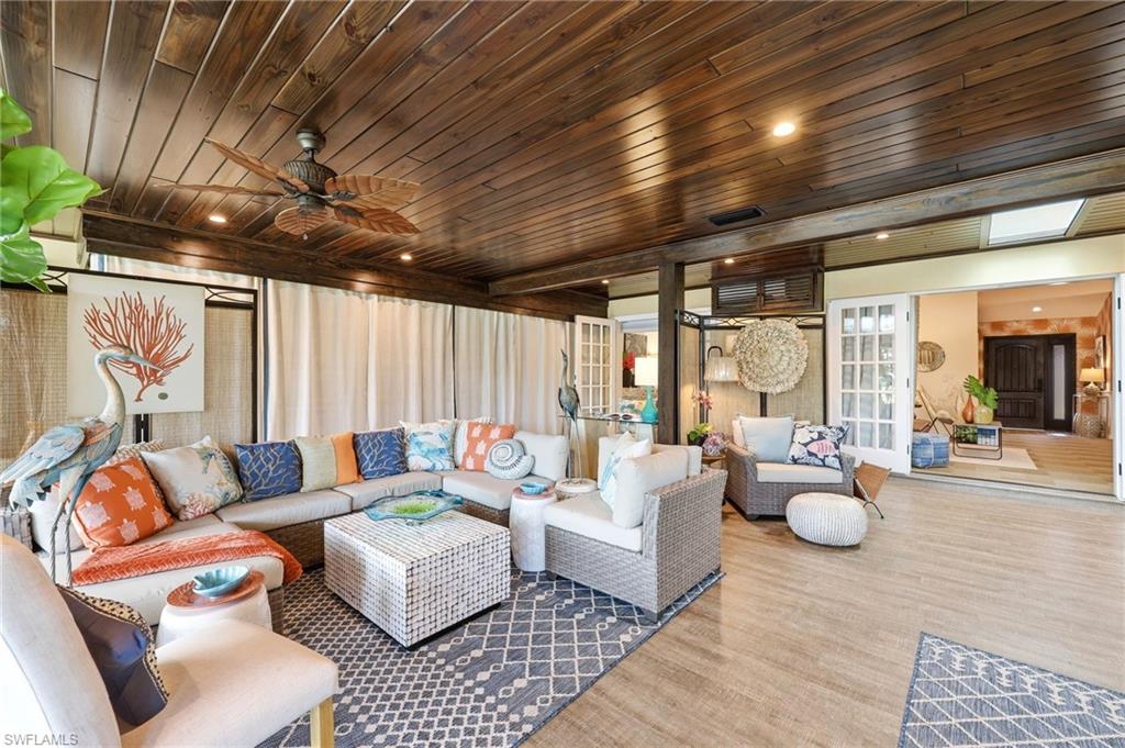 2274 Queens Way Naples, FL 34112 - Photo 12 of 32 a living room with furniture and a large window
