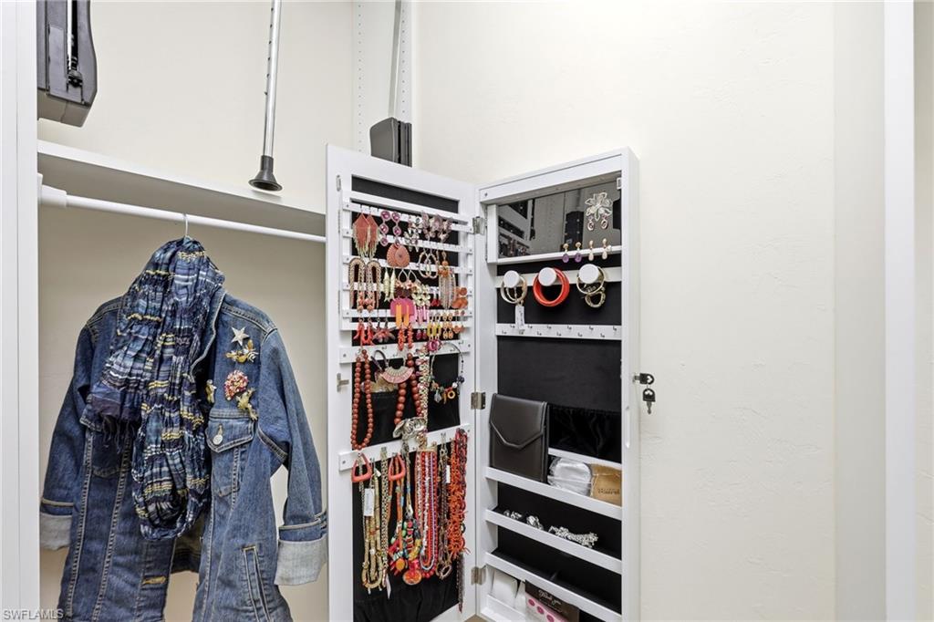 2274 Queens Way Naples, FL 34112 - Photo 20 of 32 1 of 2 walk in closets in the primary bedroom with built in jewlery storage