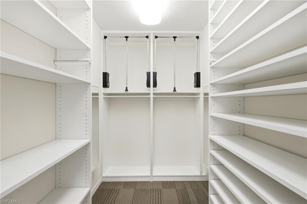 2274 Queens Way Naples, FL 34112 - Photo 21 of 32 Walk in closet also features pull down access for clothing and valet rods.