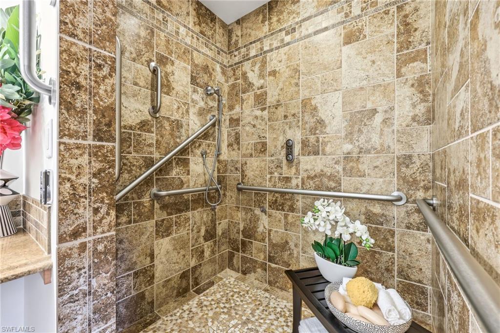 2274 Queens Way Naples, FL 34112 - Photo 24 of 32 remote control shower with roll in access and linear drain.