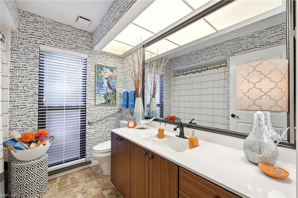 2274 Queens Way Naples, FL 34112 - Photo 27 of 32 a bathroom with a sink mirror and vanity