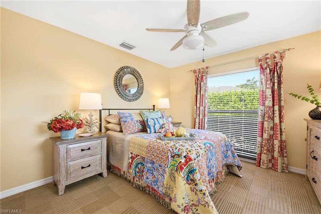 2274 Queens Way Naples, FL 34112 - Photo 28 of 32 a bedroom with a bed and a chandelier