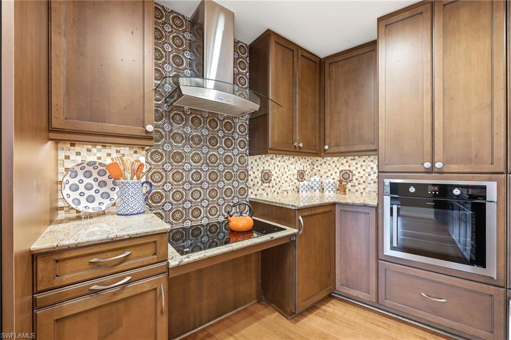 2274 Queens Way Naples, FL 34112 - Photo 8 of 32 a kitchen with stainless steel appliances granite countertop a stove and a microwave