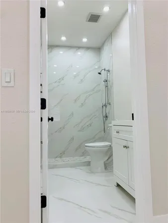 a bathroom with a sink a toilet and mirror