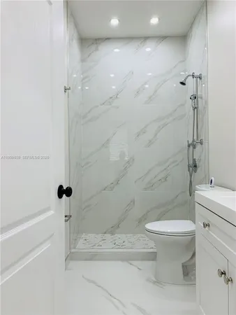 a bathroom with a sink a toilet and mirror