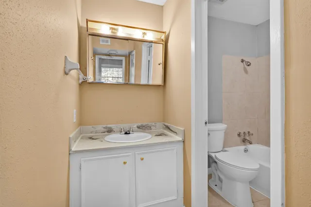 a bathroom with a sink a toilet and vanity
