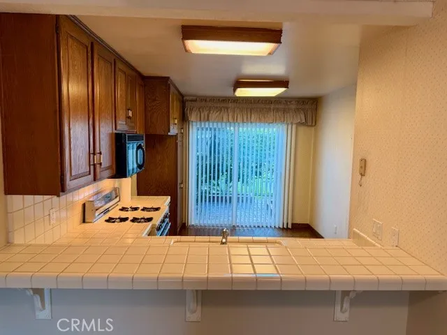 17708 La Rosa Lane Fountain Valley, CA 92708 - Photo 3 of 4 Kitchen with slider leading to front courtyard