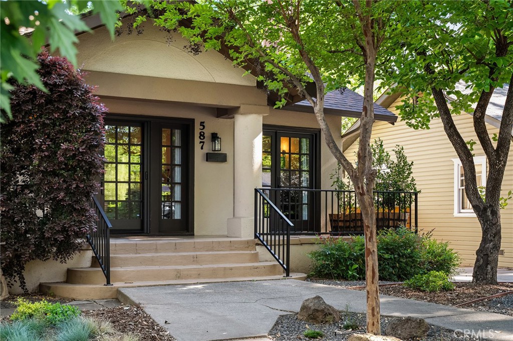 587 East 3rd Street Chico, CA 95928 - Photo 12 of 73 a front view of a house with a garden and plants