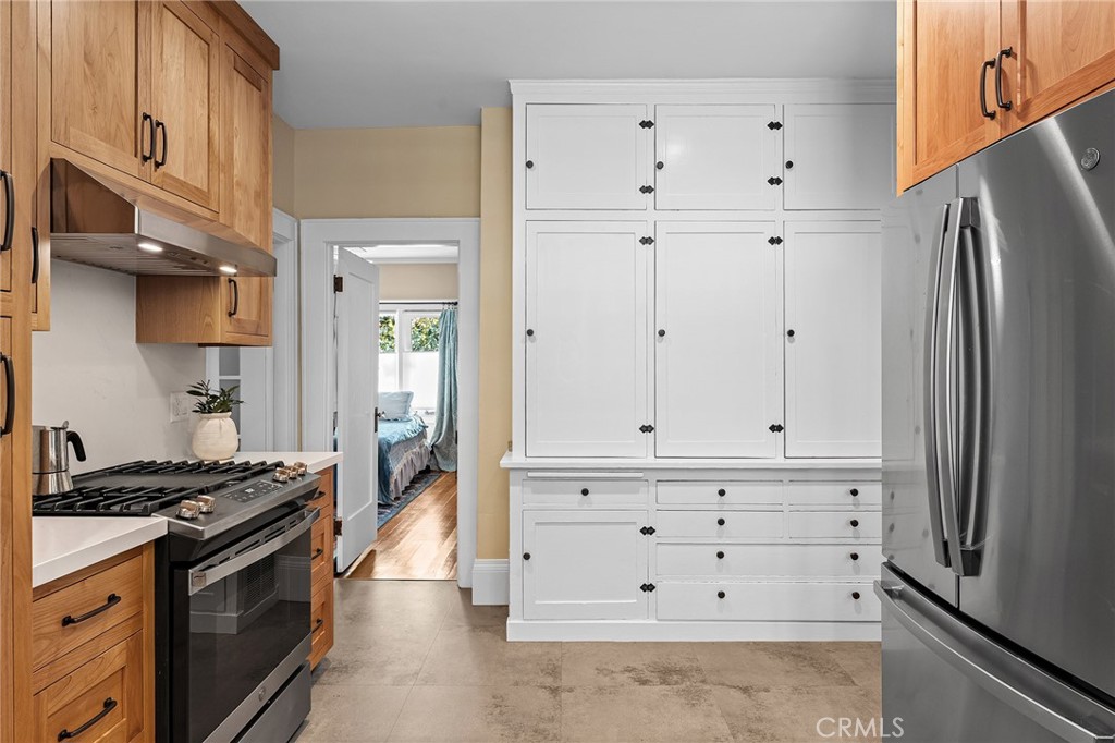 587 East 3rd Street Chico, CA 95928 - Photo 23 of 73 a kitchen with granite countertop white cabinets and stainless steel appliances