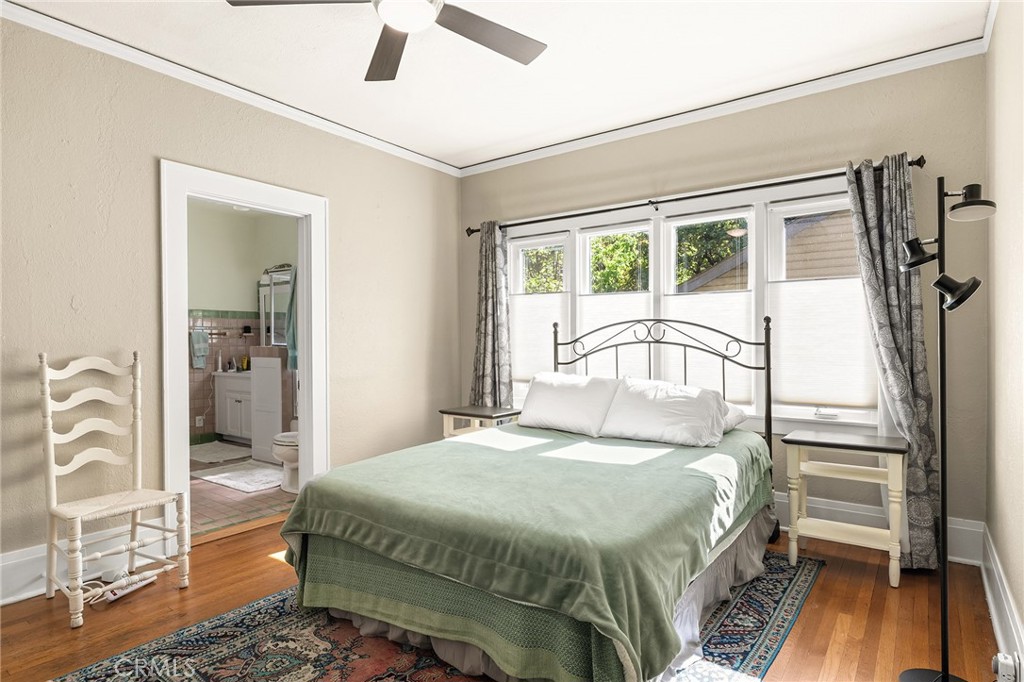 587 East 3rd Street Chico, CA 95928 - Photo 31 of 73 a bedroom with a bed next to a large window with wooden floor