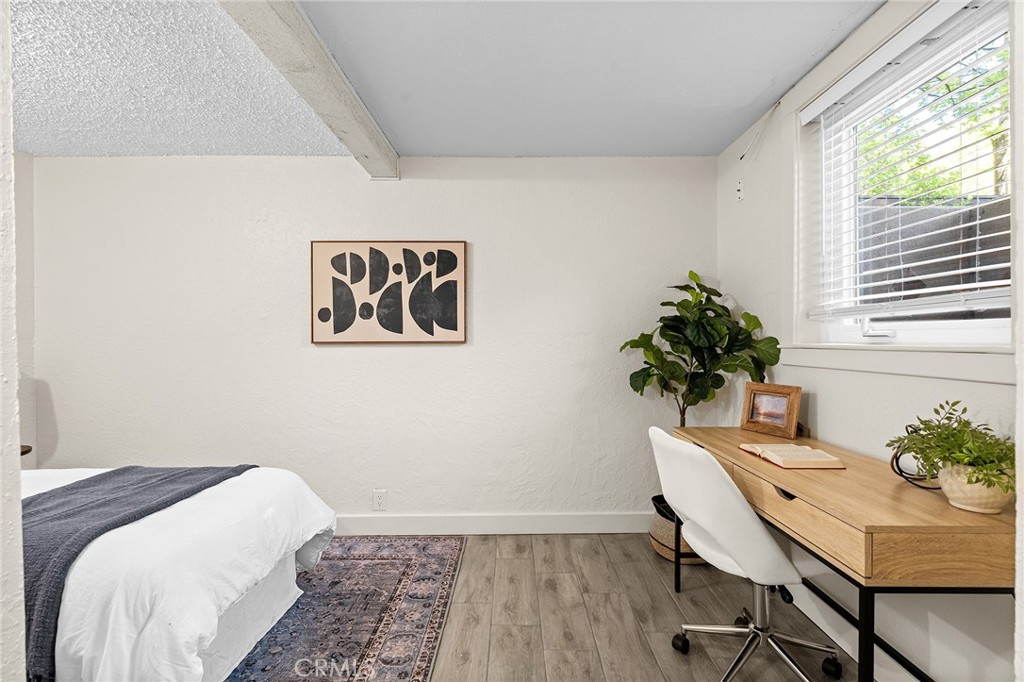 587 East 3rd Street Chico, CA 95928 - Photo 51 of 73 a bedroom with a table and a chair