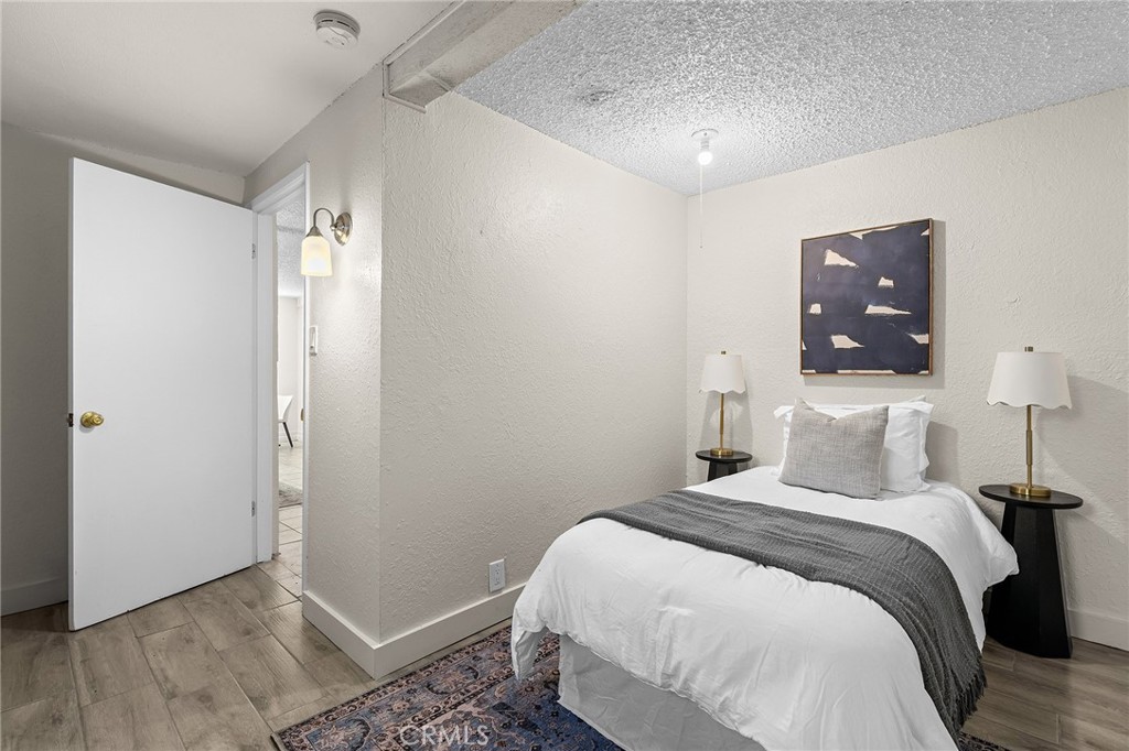 587 East 3rd Street Chico, CA 95928 - Photo 52 of 73 a bedroom with a bed and wooden floor