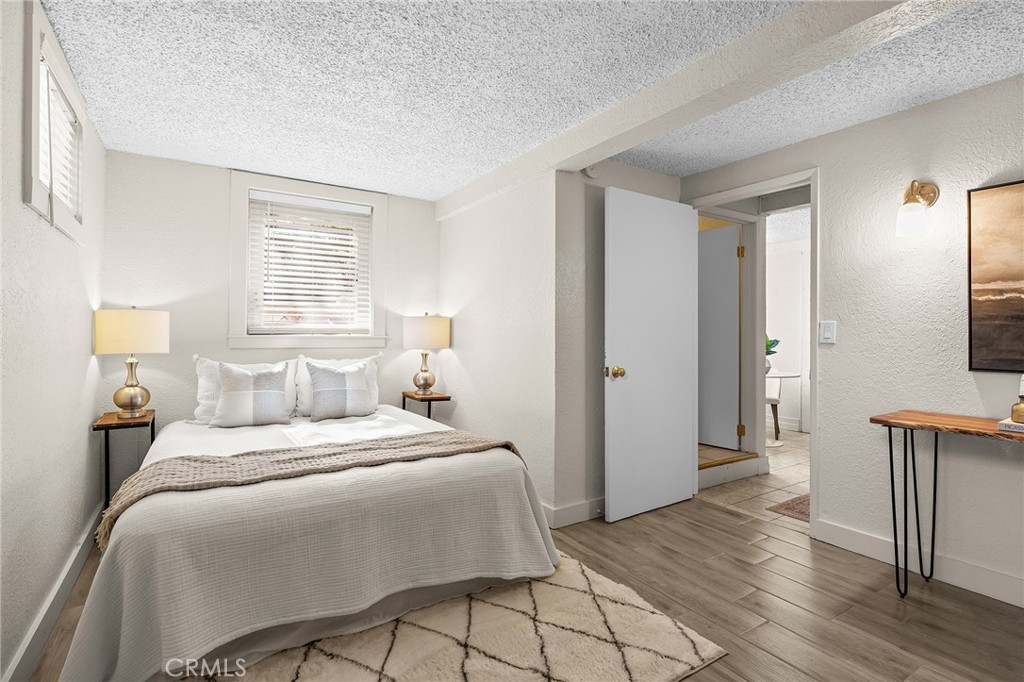 587 East 3rd Street Chico, CA 95928 - Photo 53 of 73 a bedroom with a bed and wooden floor