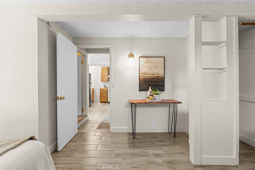587 East 3rd Street Chico, CA 95928 - Photo 54 of 73 a view of a hallway with wooden floor and a living room