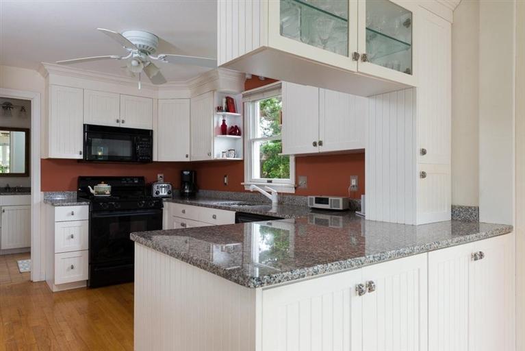 165 Bay Shore Road Hyannis, MA 02601 - Photo 9 of 26 a kitchen with granite countertop a sink a counter top space appliances and cabinets