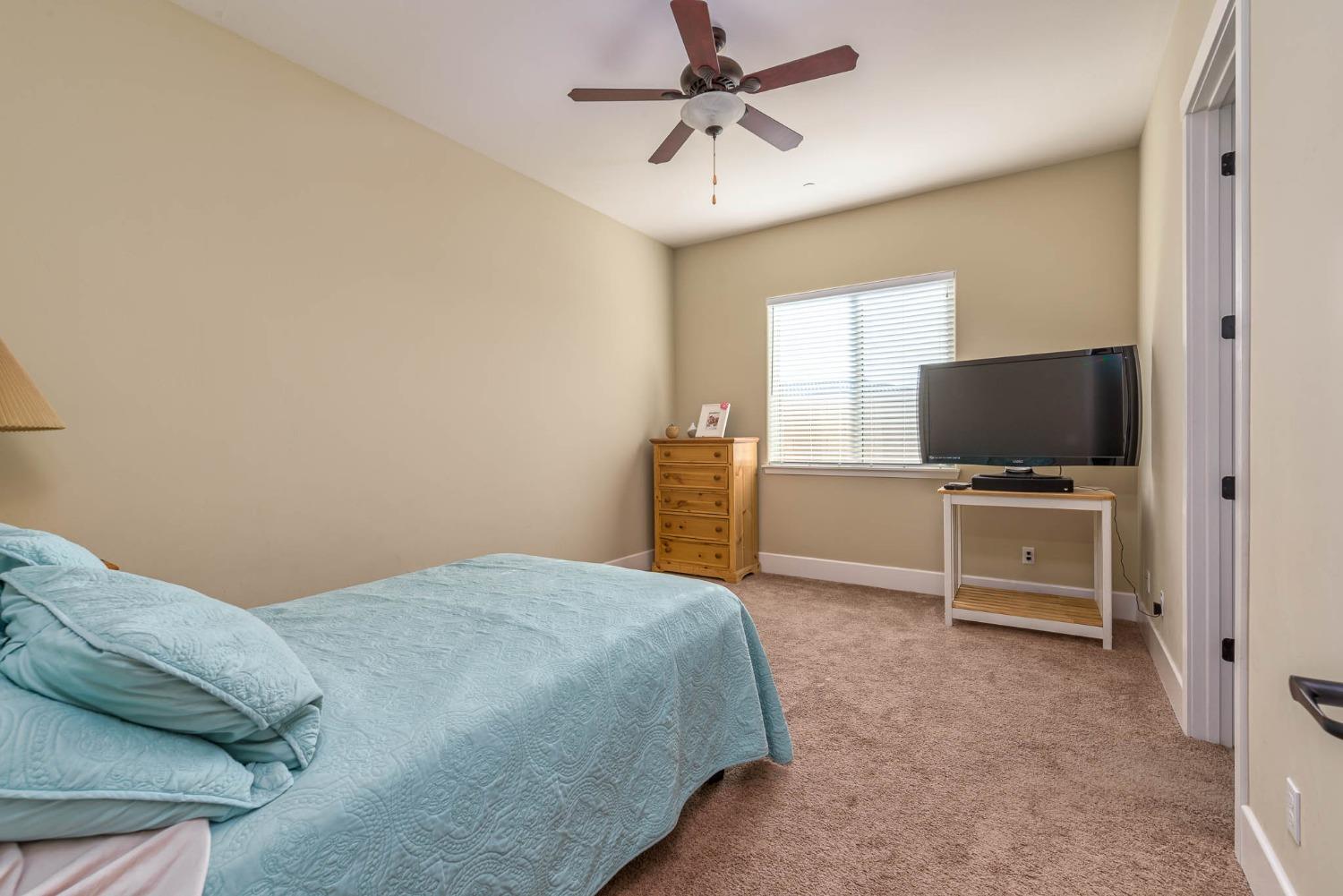 3230 Enterprise Avenue Clovis, CA 93619 - Photo 15 of 41 a bedroom with a bed and flat screen tv