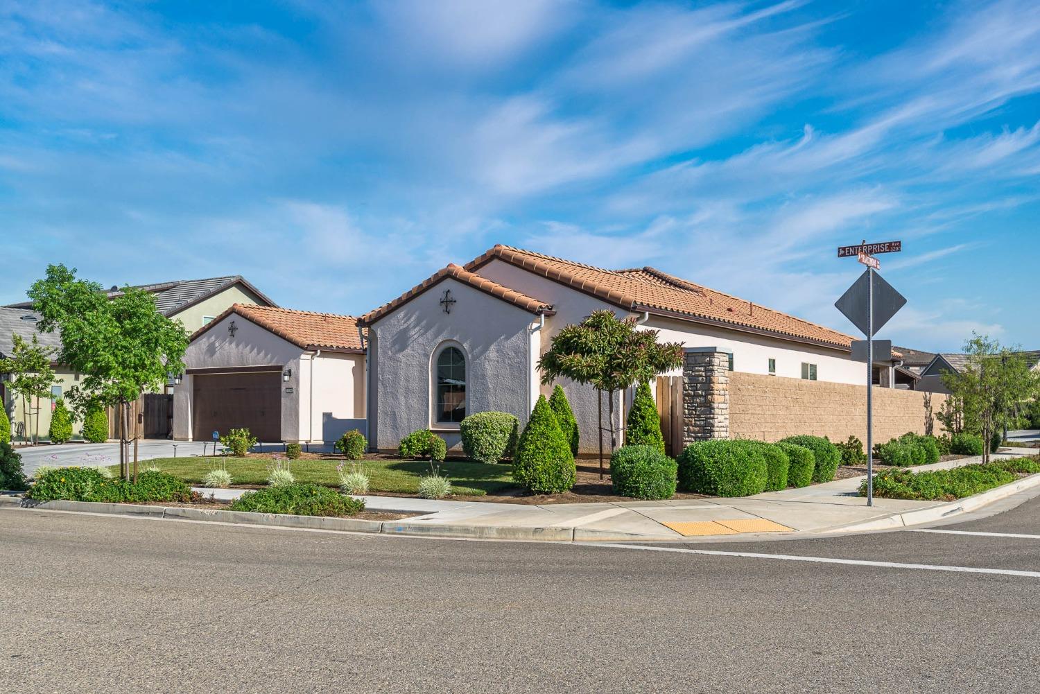 3230 Enterprise Avenue Clovis, CA 93619 - Photo 3 of 41 a front view of a house with a yard and potted plants