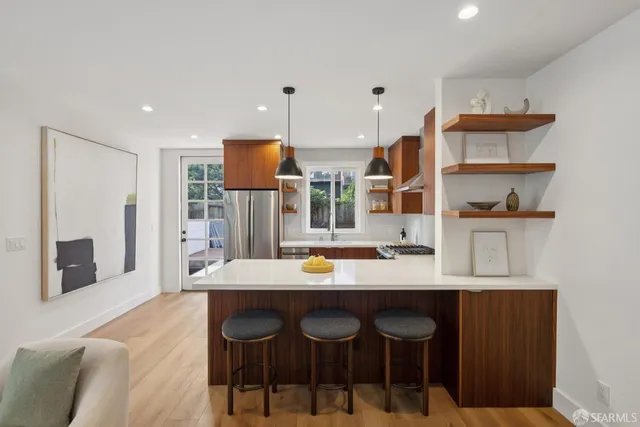 a hallway with a view of living room and window