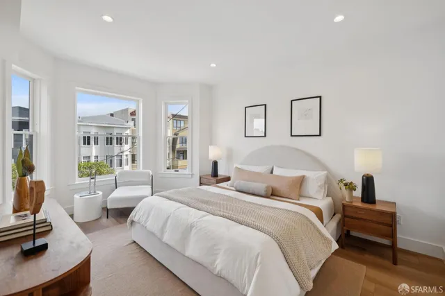 a bedroom with a bed and a night stand