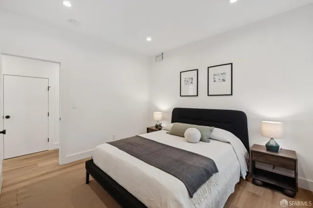 a living room with furniture a flat screen tv and kitchen view