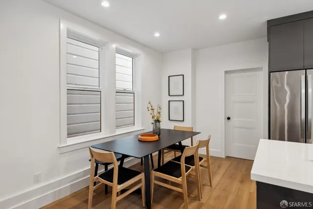 a room with a table chairs and projector