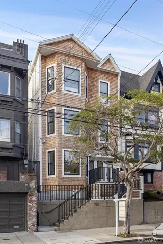 a front view of a residential apartment building with a yard