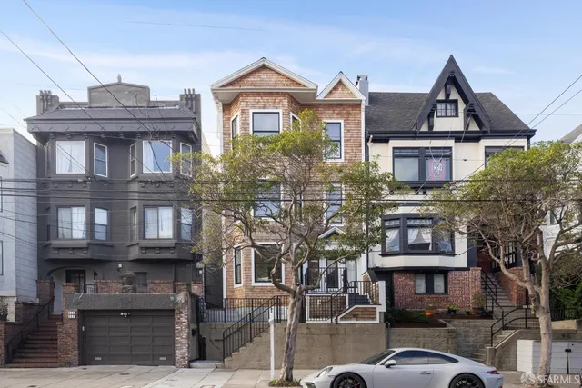 a front view of a residential apartment building with a yard