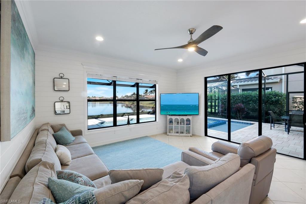 2735 Cinnamon Bay Circle Naples, FL 34119 - Photo 11 of 50 a living room with furniture and a large window