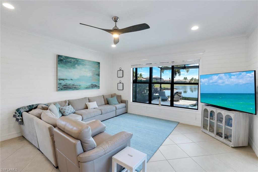 2735 Cinnamon Bay Circle Naples, FL 34119 - Photo 13 of 50 a living room with furniture and a flat screen tv