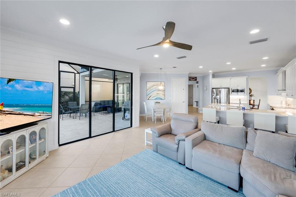2735 Cinnamon Bay Circle Naples, FL 34119 - Photo 14 of 50 a living room with furniture and a large window