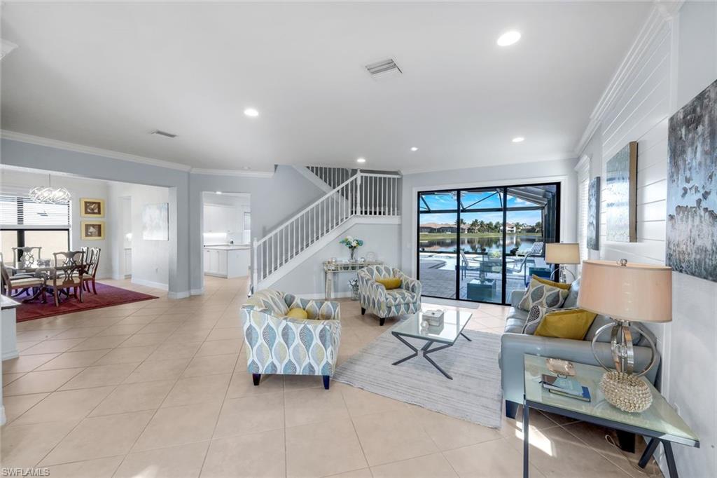 2735 Cinnamon Bay Circle Naples, FL 34119 - Photo 15 of 50 a living room with furniture and a large window
