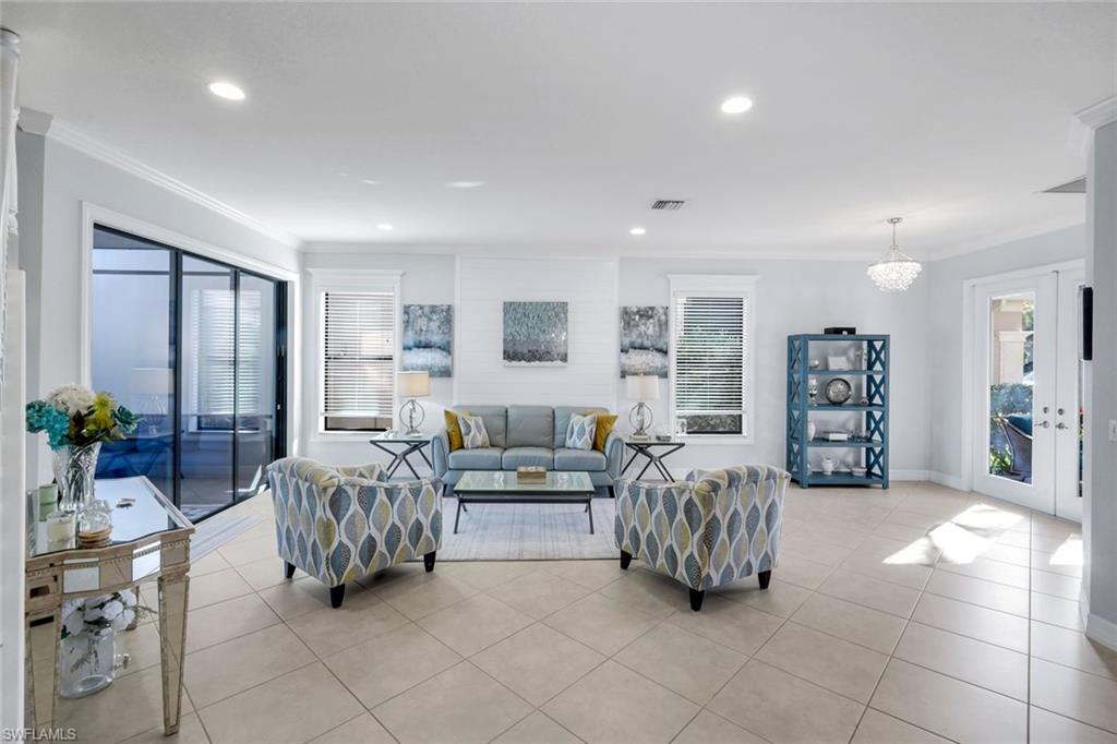 2735 Cinnamon Bay Circle Naples, FL 34119 - Photo 16 of 50 a living room with furniture and a large window